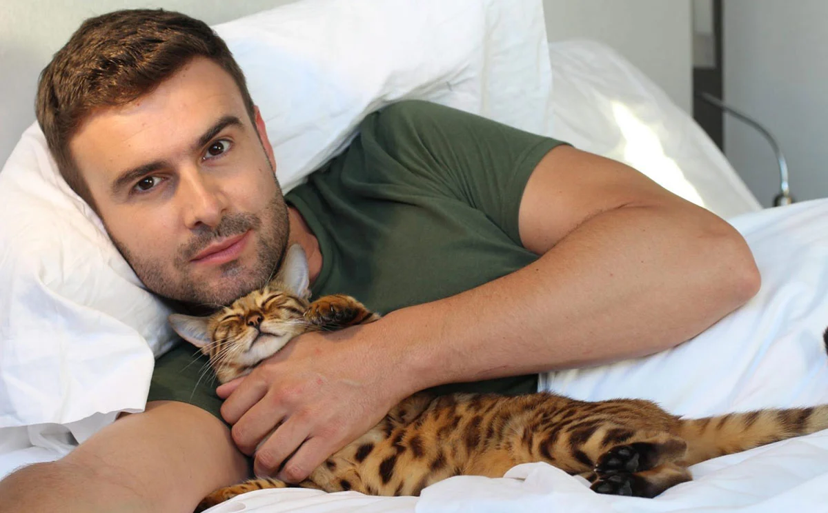 Man sleeping with his cat