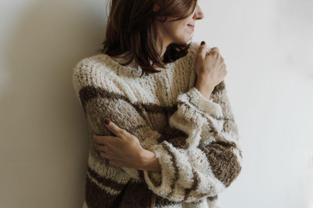 Person embracing themselves and prioritizing emotional well-being while dating
